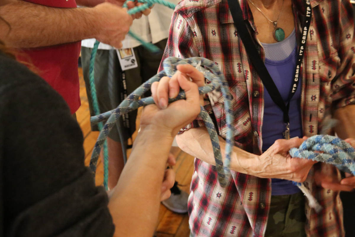 hands holding and tying climbing ropes